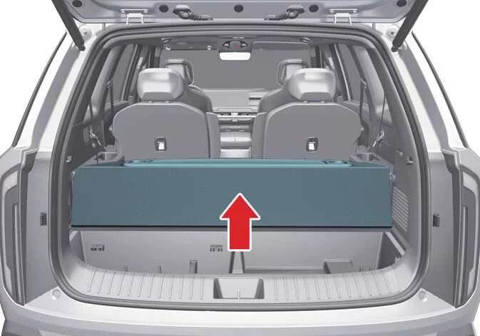 Accessing the storage tray to stow the cargo screen