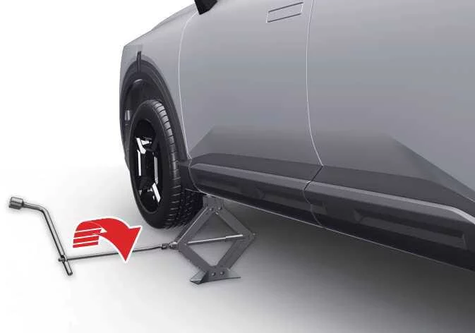 Raising the vehicle using the jack handle on a Kia Telluride