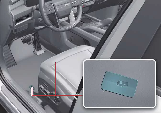 Floor mat anchor posts on the driver-side carpet of the Kia Telluride