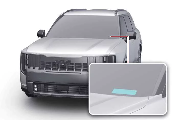 Close-up of the VIN plate visible through the Kia Telluride windshield